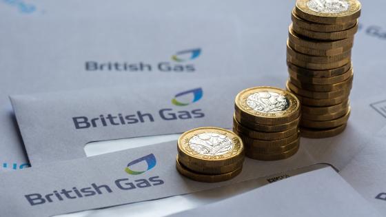 Stacks of One Pound coins on top of British Gas bills 